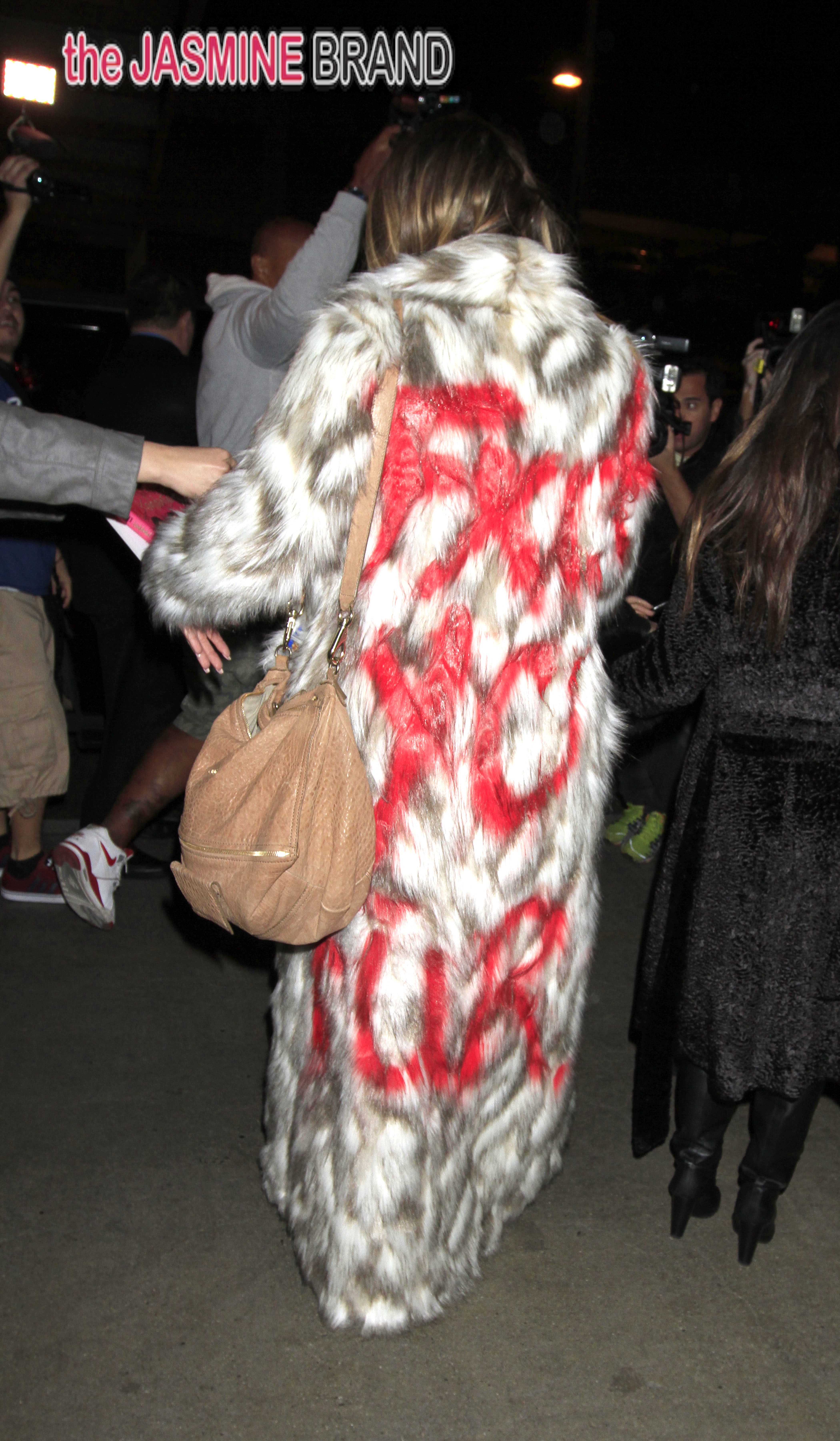 Khloe Kardashian wears a fur that says 'FXCK YO FUR' as she shows her support for banning for.  Kourtney Kardashian was also seen with her sister at LAX.
