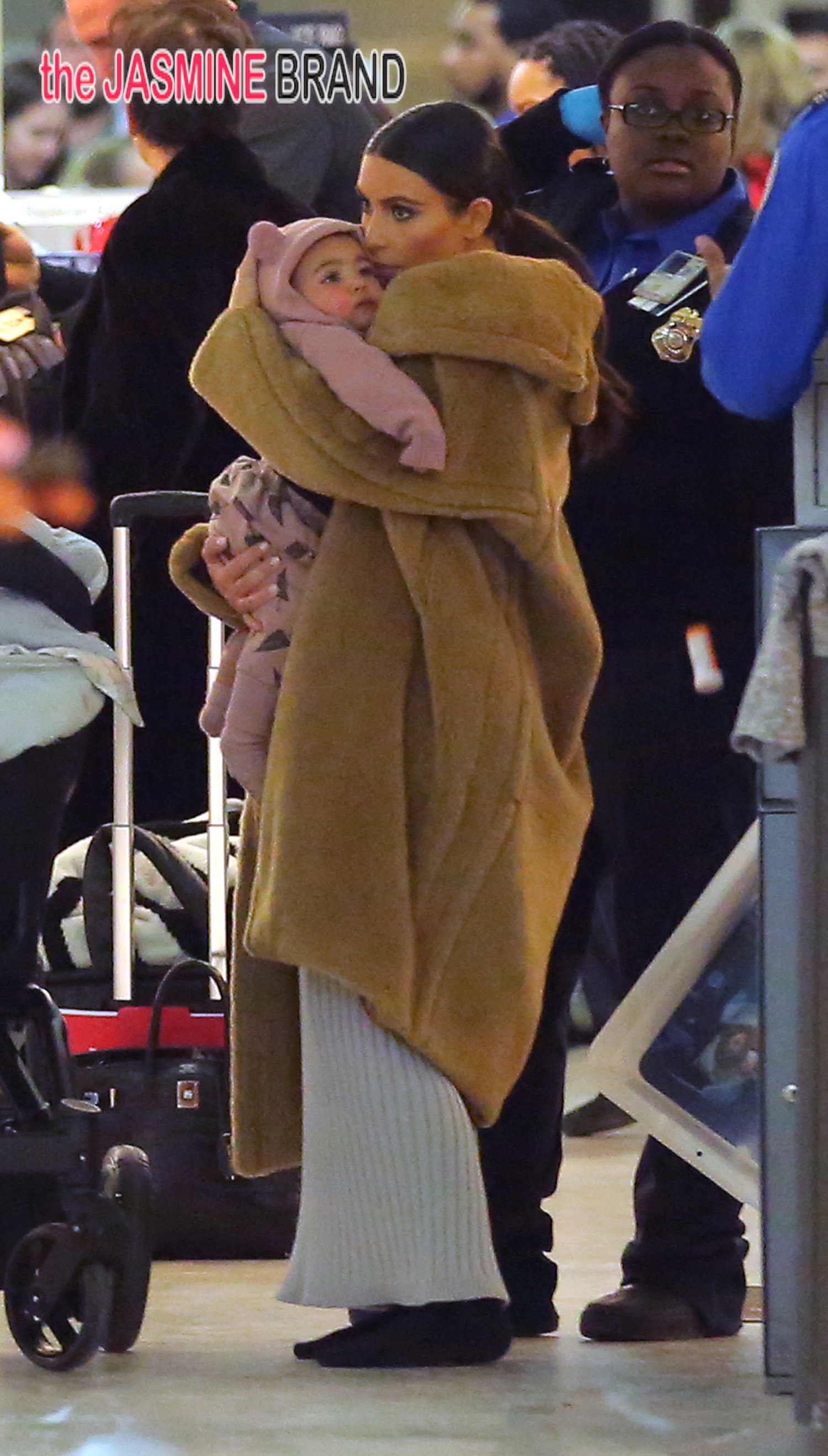 Kim Kardashian holds baby North West while wearing a fur coat NYC