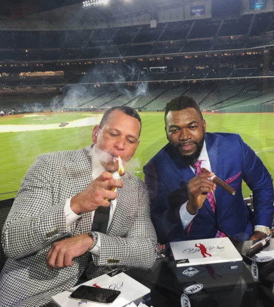 David Ortiz gives Alex Rodriguez a champagne shower while wearing a Red Sox  jersey