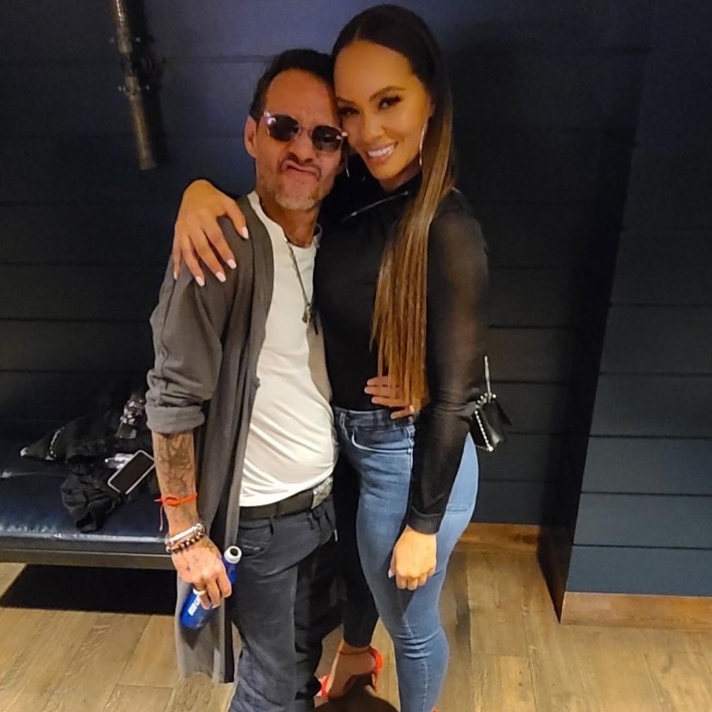 Evelyn Lozada hugs Marc Anthony backstage, as she attends a concert